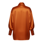 Orange satin blouse with pearl buttons on a white background