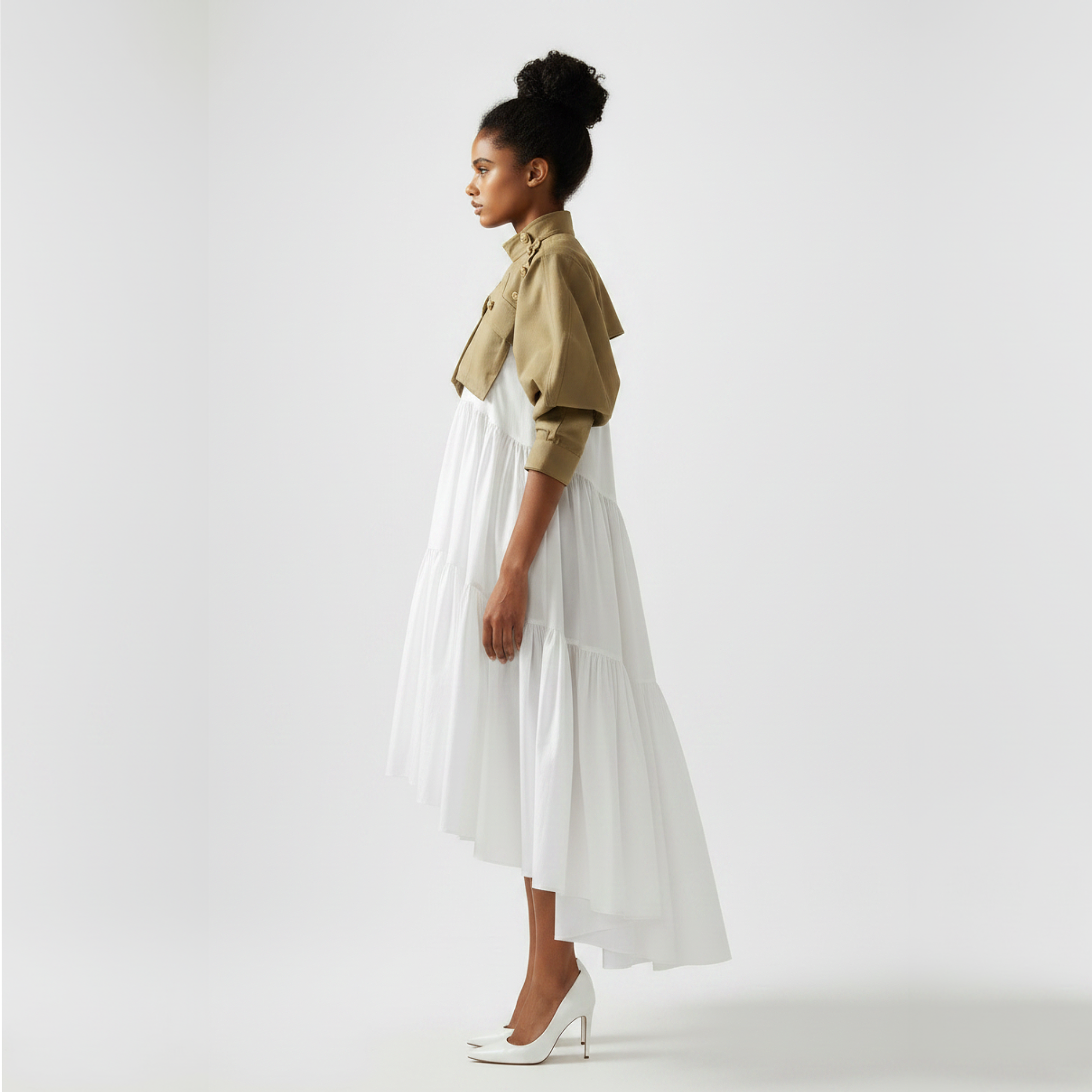 Woman wearing a beige shirt and white skirt on a plain background