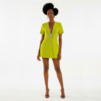 Woman wearing a bright green dress with a starburst pattern on a white background