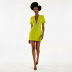 Woman wearing a bright green dress with a starburst pattern on a white background