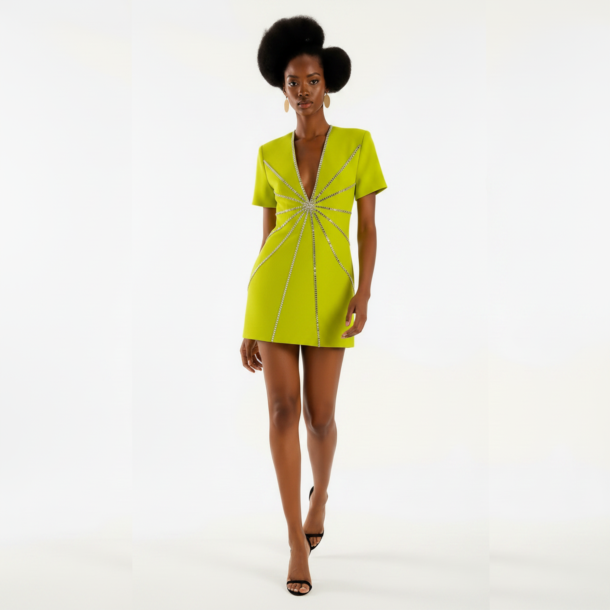 Woman wearing a bright green dress with a starburst pattern on a white background