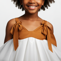 White tiered dress worn by a person on a black background