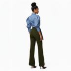 Woman wearing a blue blouse and green pants on a white background