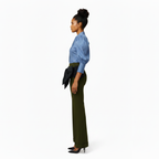 Woman wearing a blue blouse and green pants on a white background