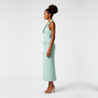 Woman wearing a light green dress on a white background