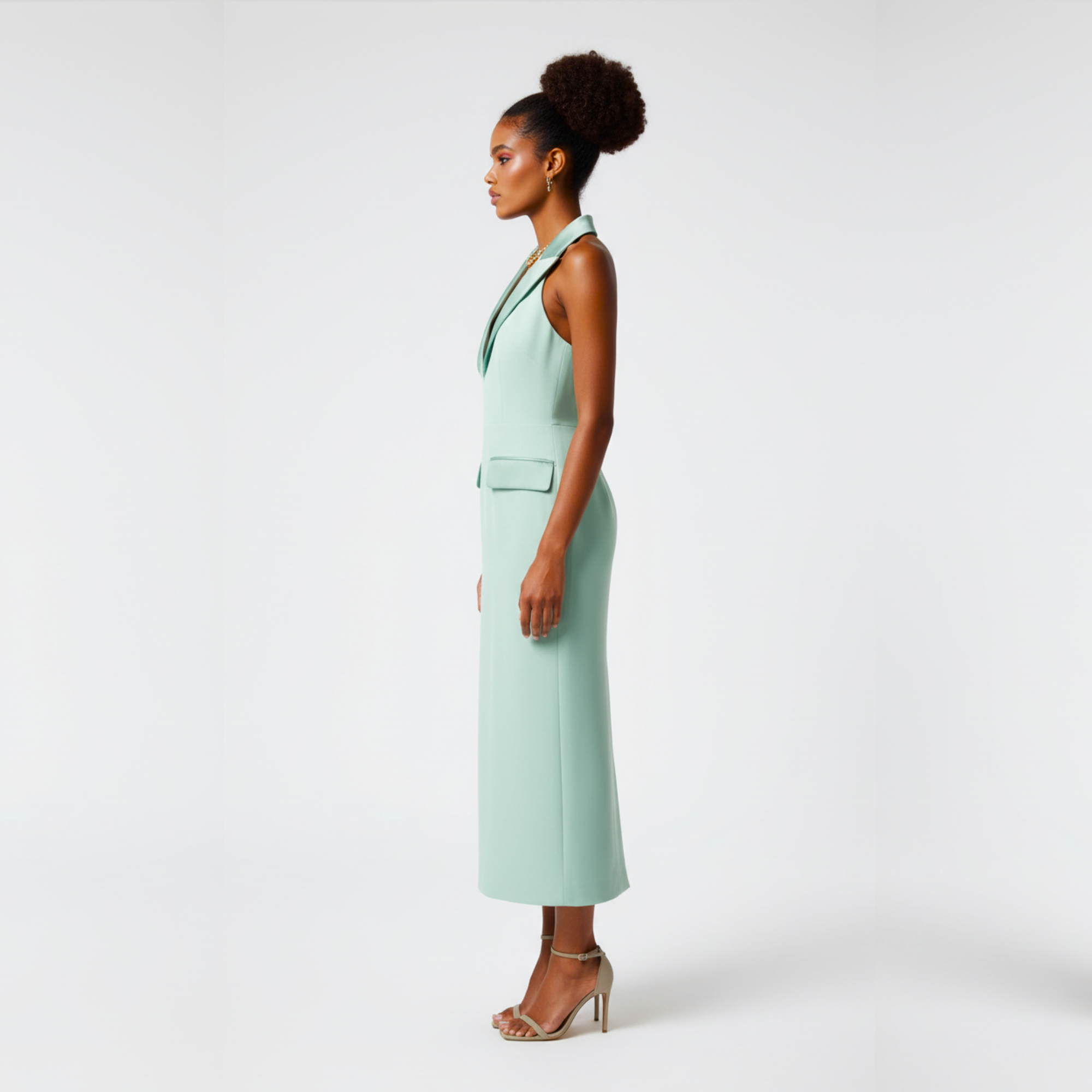 Woman wearing a light green dress on a white background