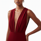 Red dress with a plunging neckline worn by a model on a white background
