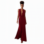Woman wearing a deep red evening gown on a white background