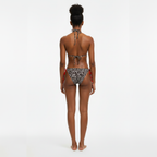 Person wearing a patterned bikini on a white background