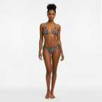 Woman wearing a leopard print bikini on a white background