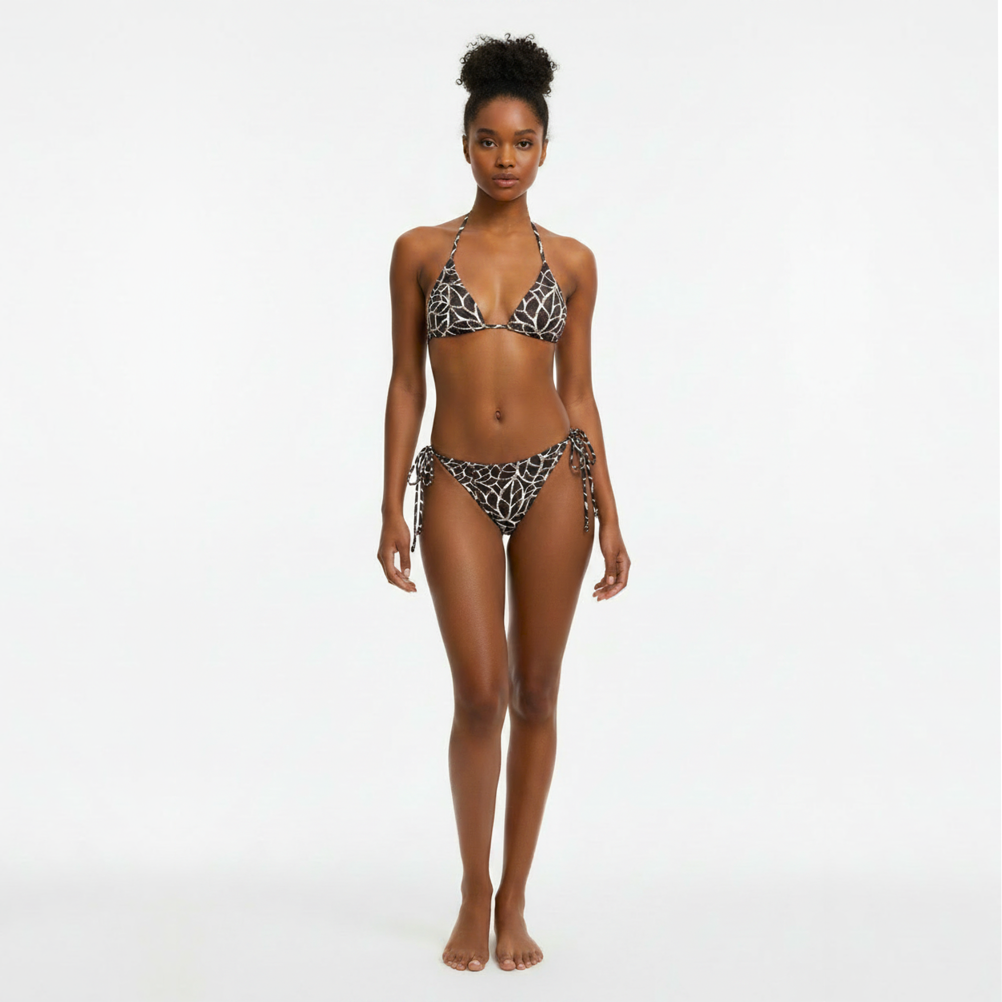 Woman wearing a leopard print bikini on a white background