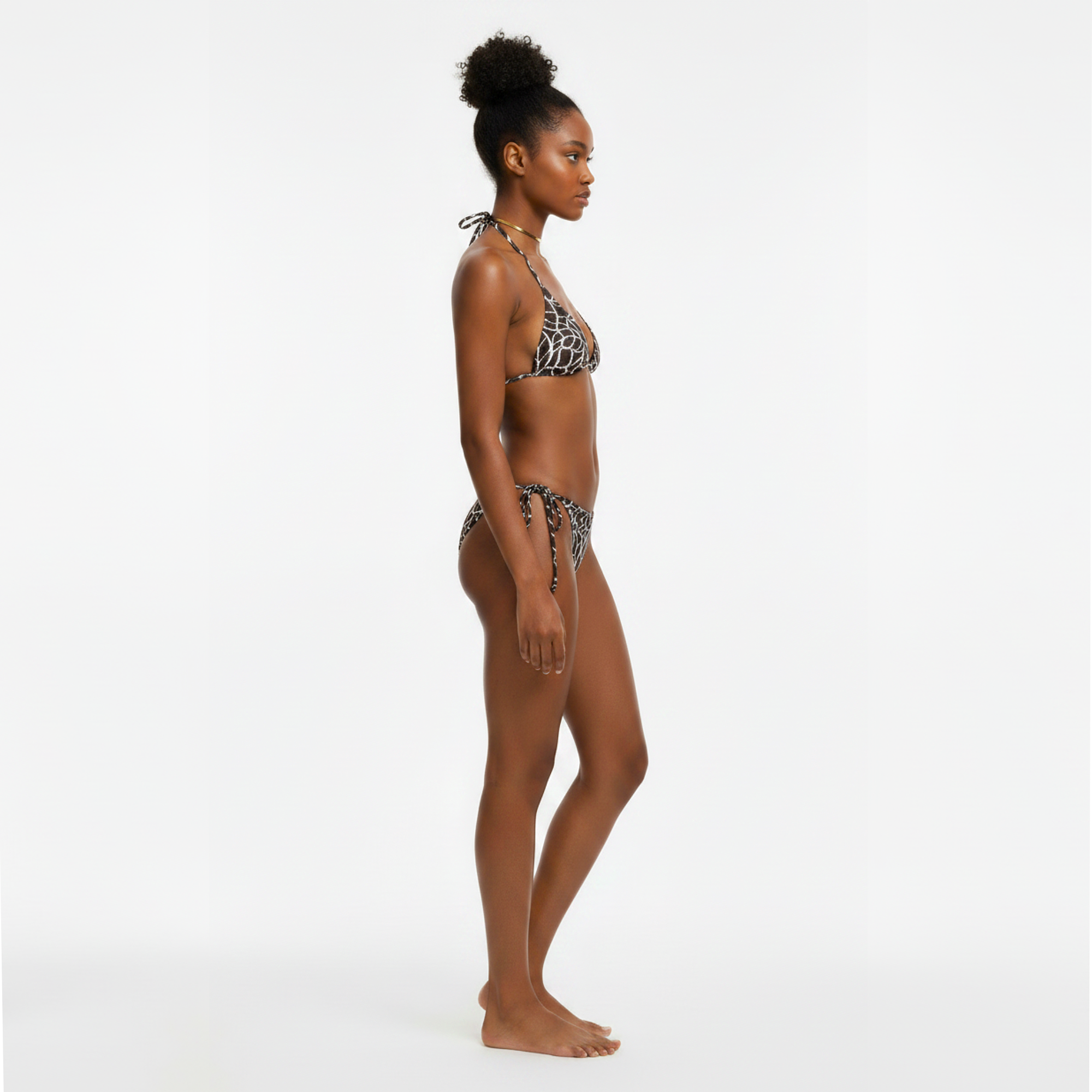 Woman wearing a leopard print bikini on a white background