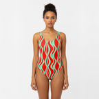 Woman wearing a red and green patterned swimsuit on a white background