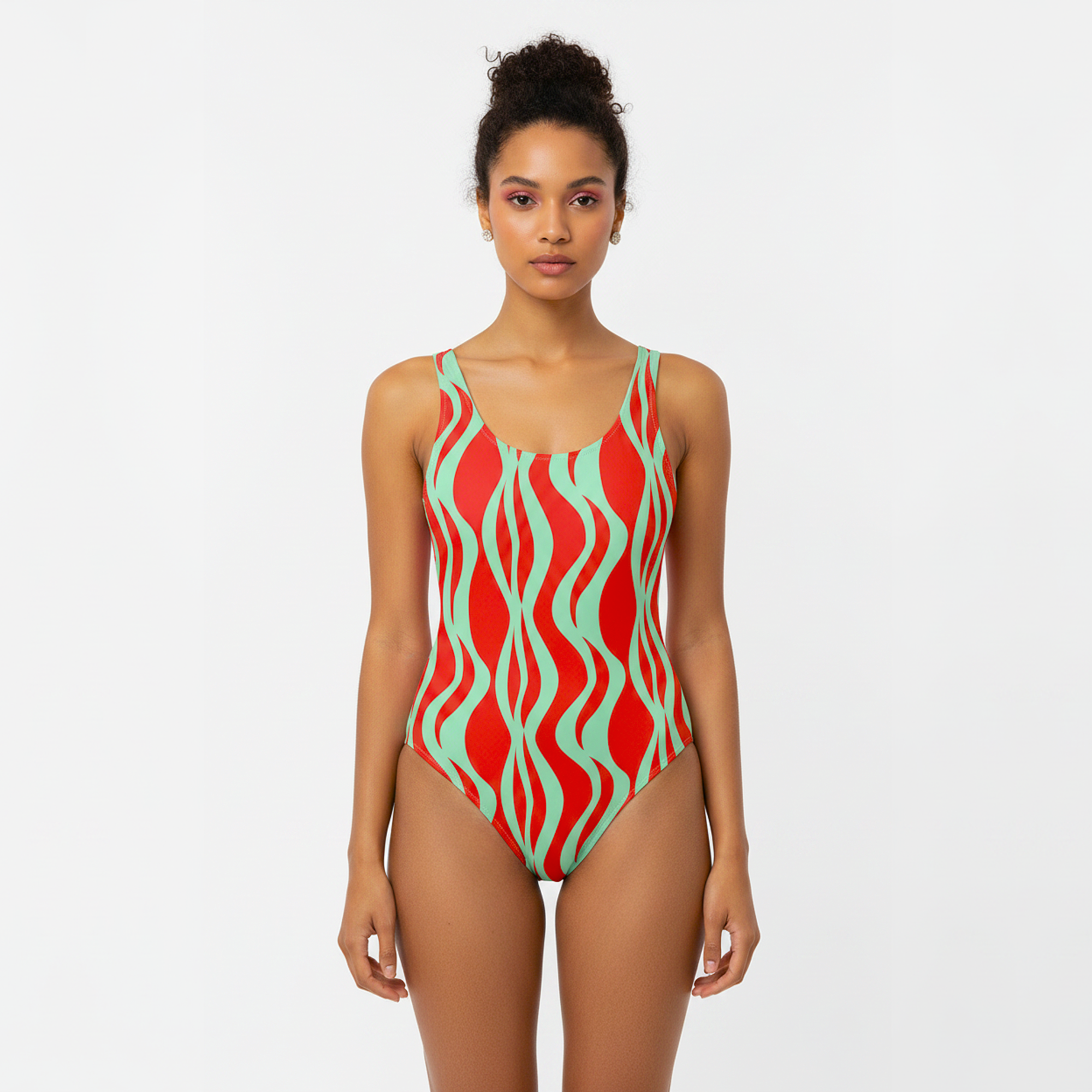Woman wearing a red and green patterned swimsuit on a white background