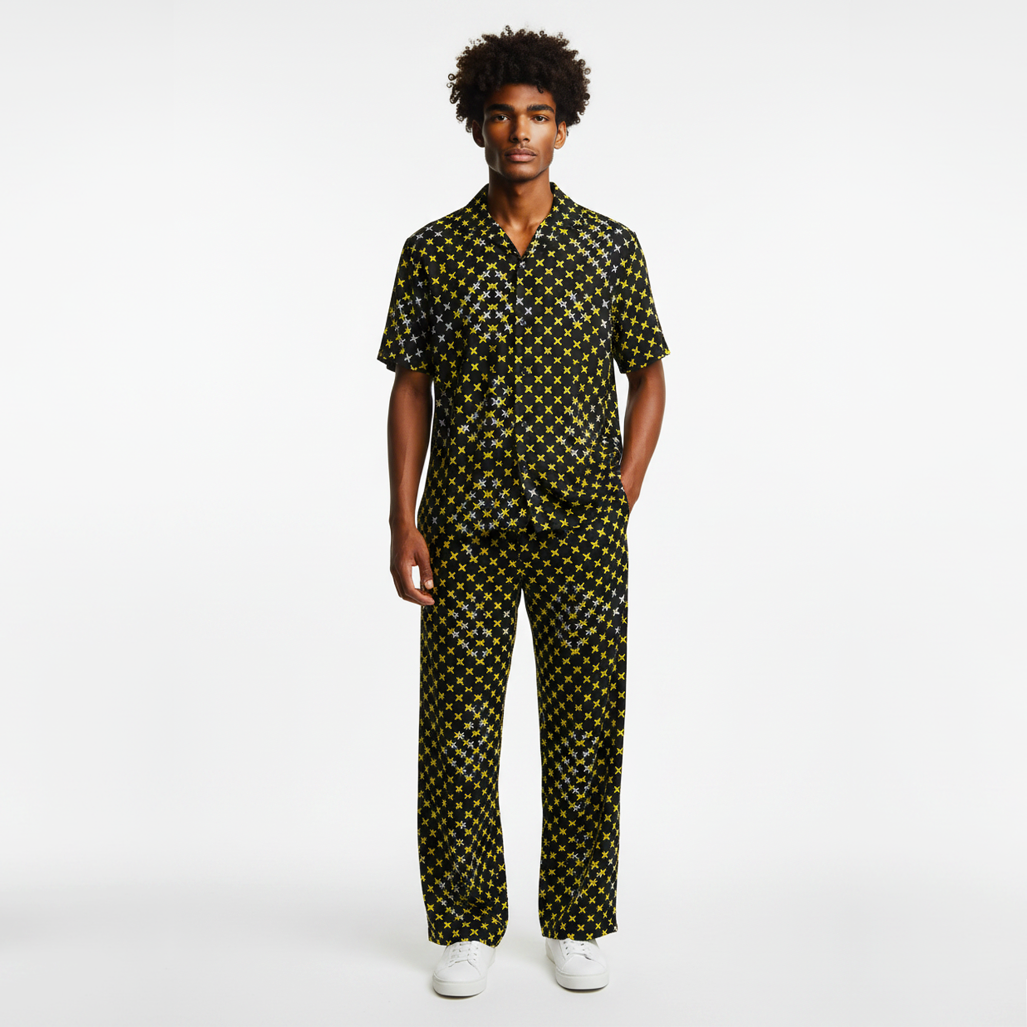 Man wearing a black and yellow patterned outfit on a white background