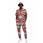 Person wearing a red and black patterned outfit with a matching hat on a white background