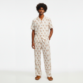 Man wearing a patterned pajama set on a white background