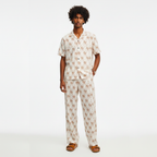 Man wearing a patterned pajama set on a white background