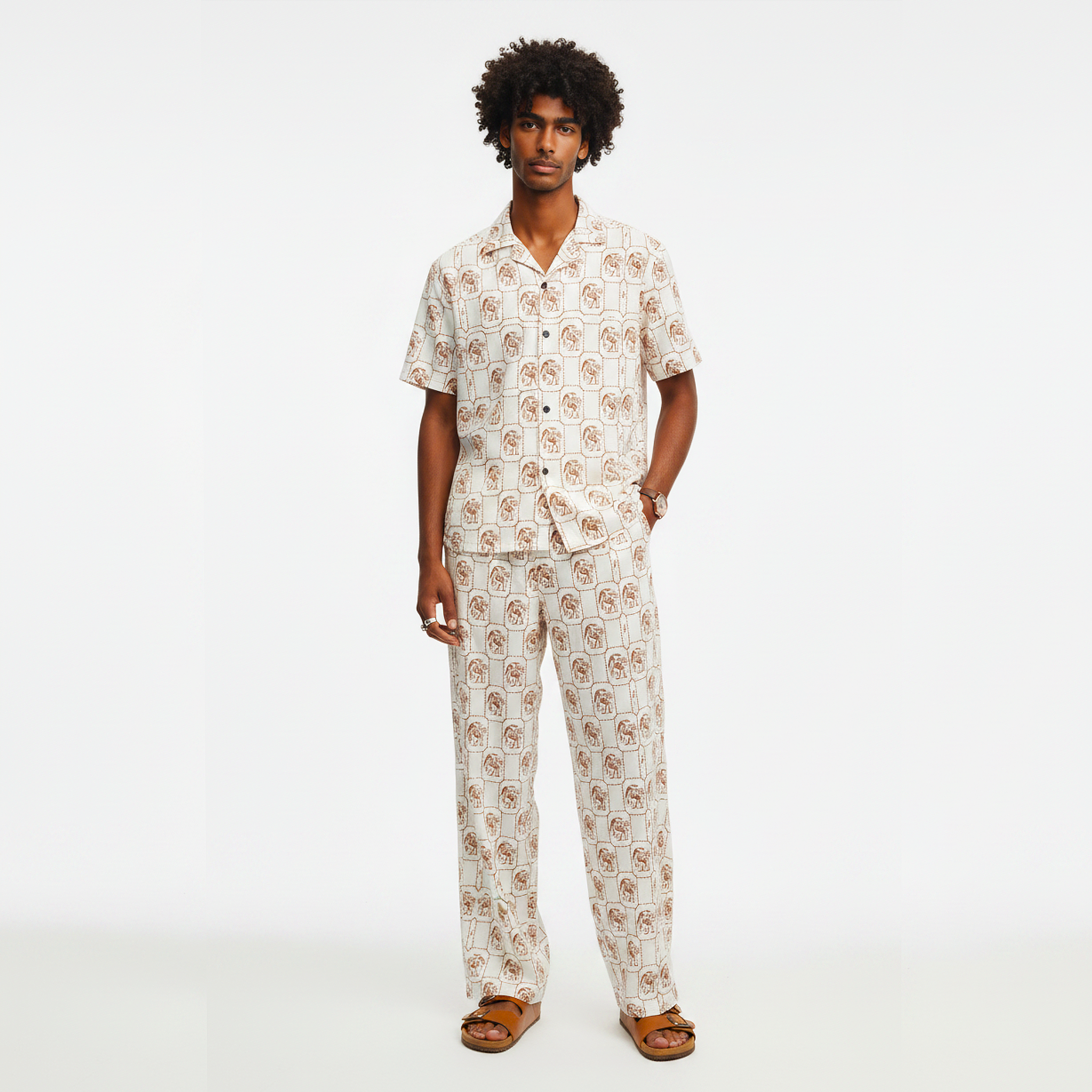 Man wearing a patterned pajama set on a white background