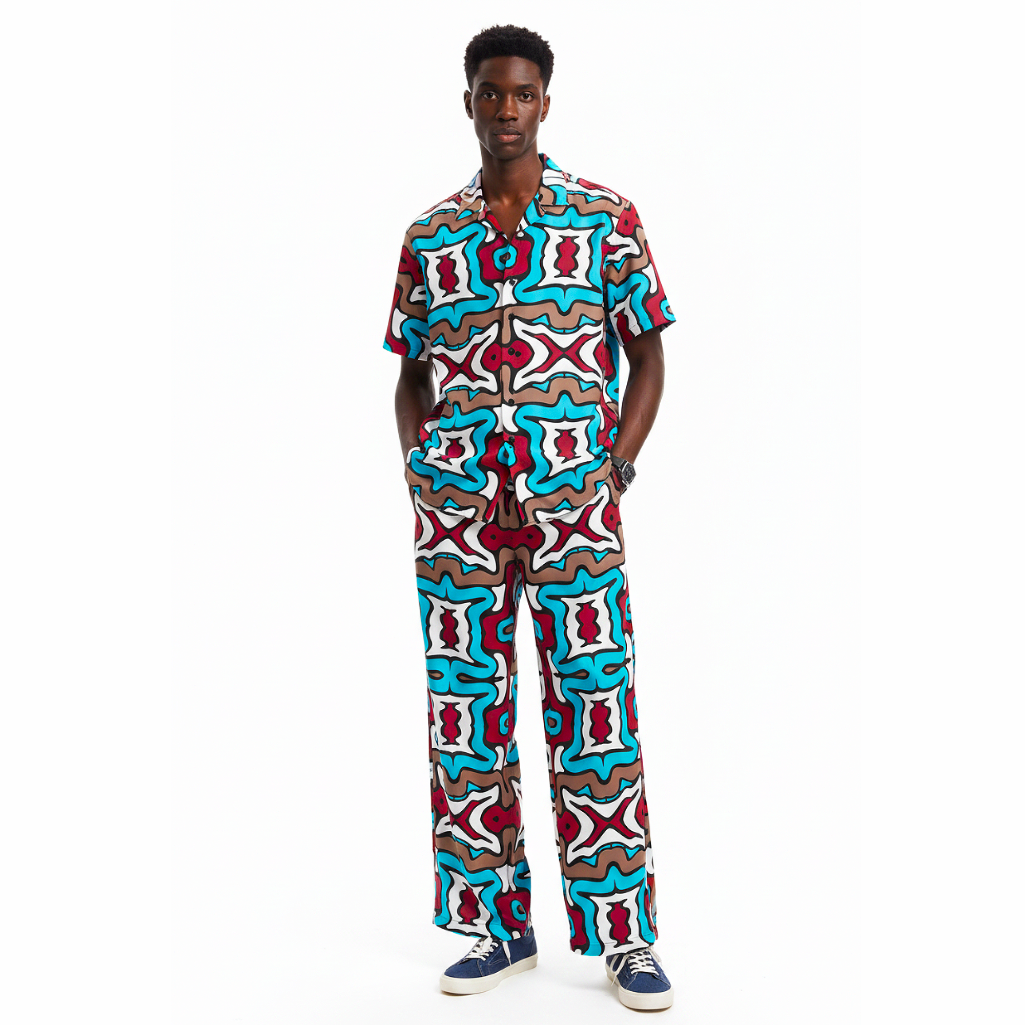Person wearing a colorful patterned outfit on a white background