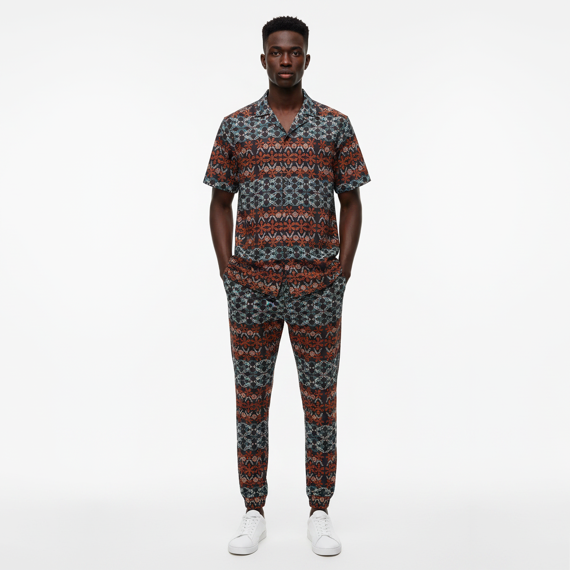 Man wearing a patterned outfit on a white background