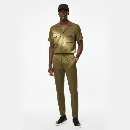Man wearing a gold outfit with a matching cap on a white background