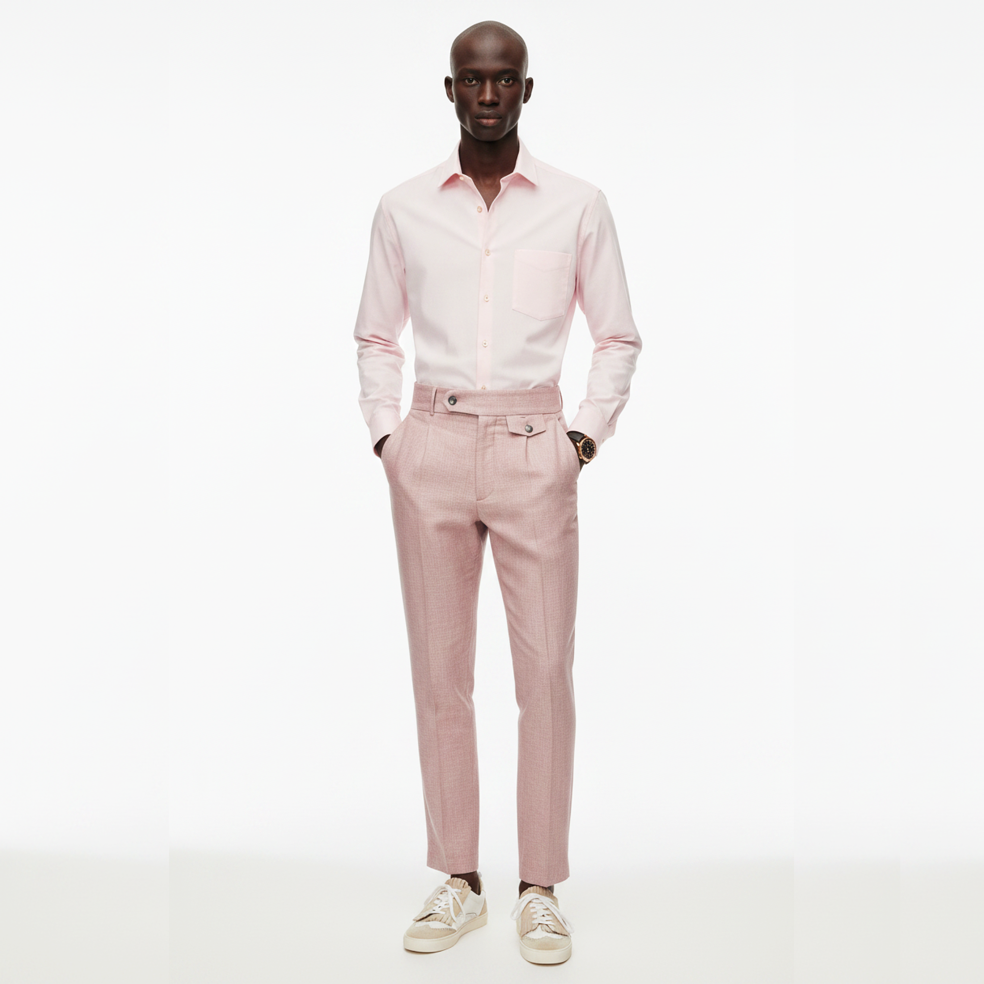 Man wearing a light pink shirt and pants on a white background