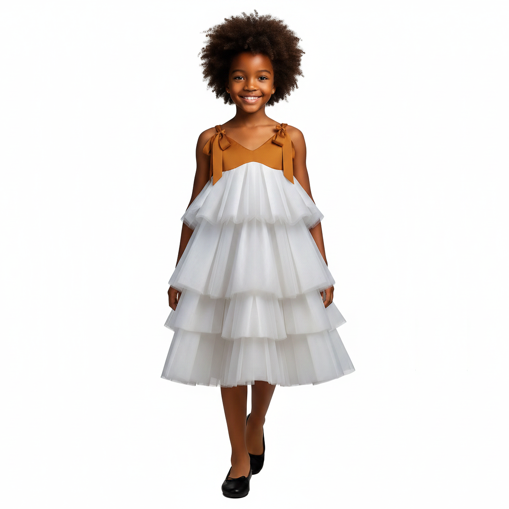 Young girl wearing a white tiered dress with a brown top on a black background