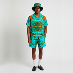 Man wearing a matching shirt and shorts set with a hat on a white background