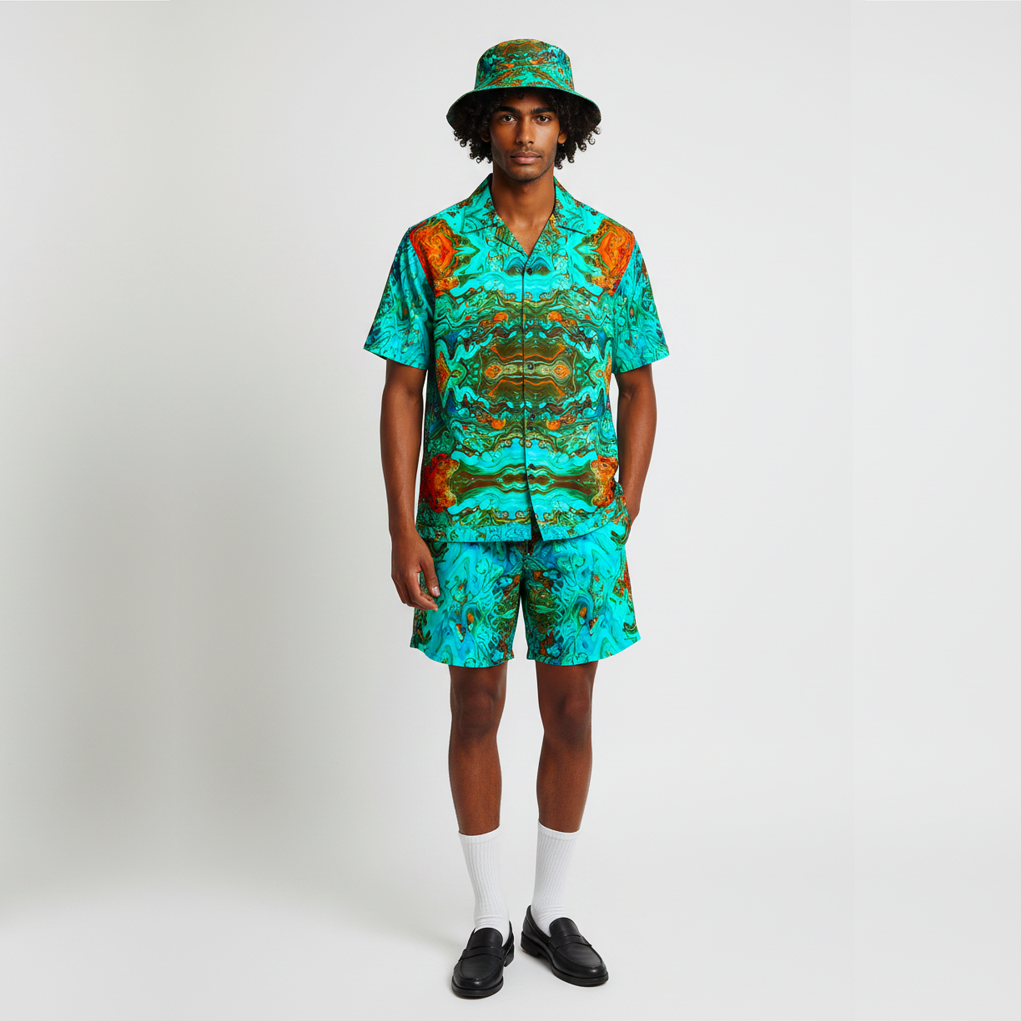 Man wearing a matching shirt and shorts set with a hat on a white background