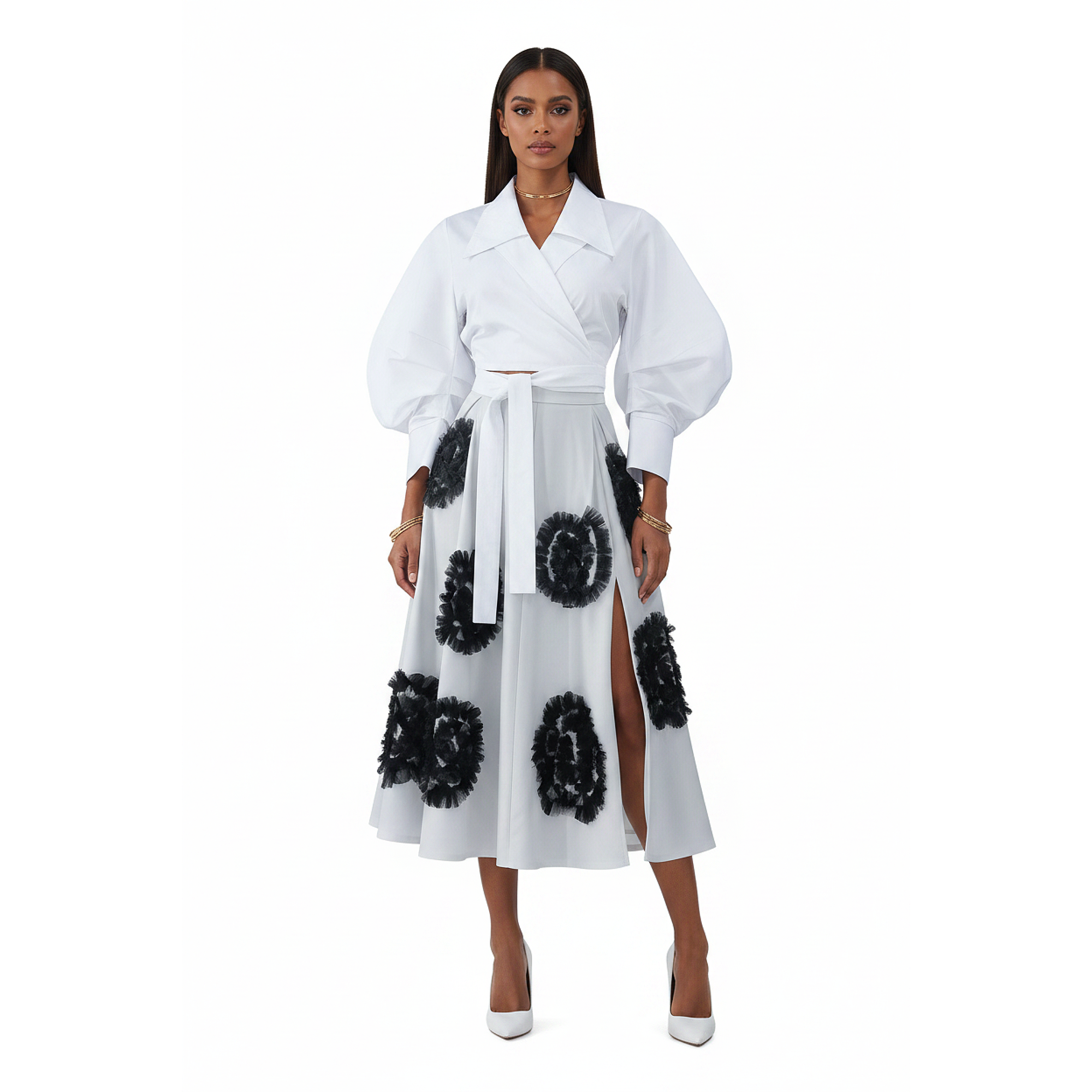 Woman wearing a white outfit with black floral patterns on a white background
