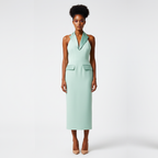 Woman wearing a light green dress against a white background