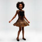 Child wearing a leopard print dress with a large black bow on a gray background
