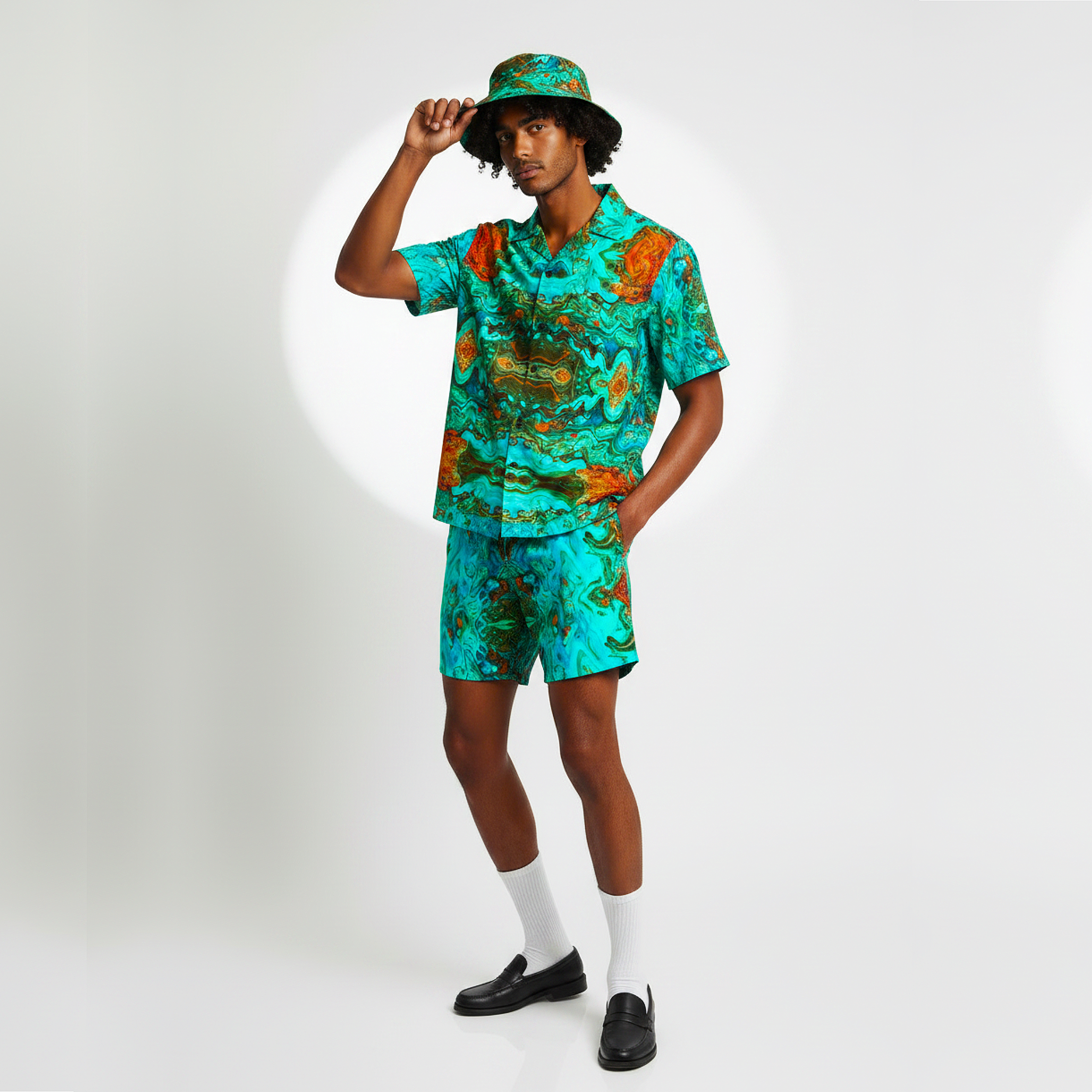 Person wearing a colorful outfit with a matching hat on a white background