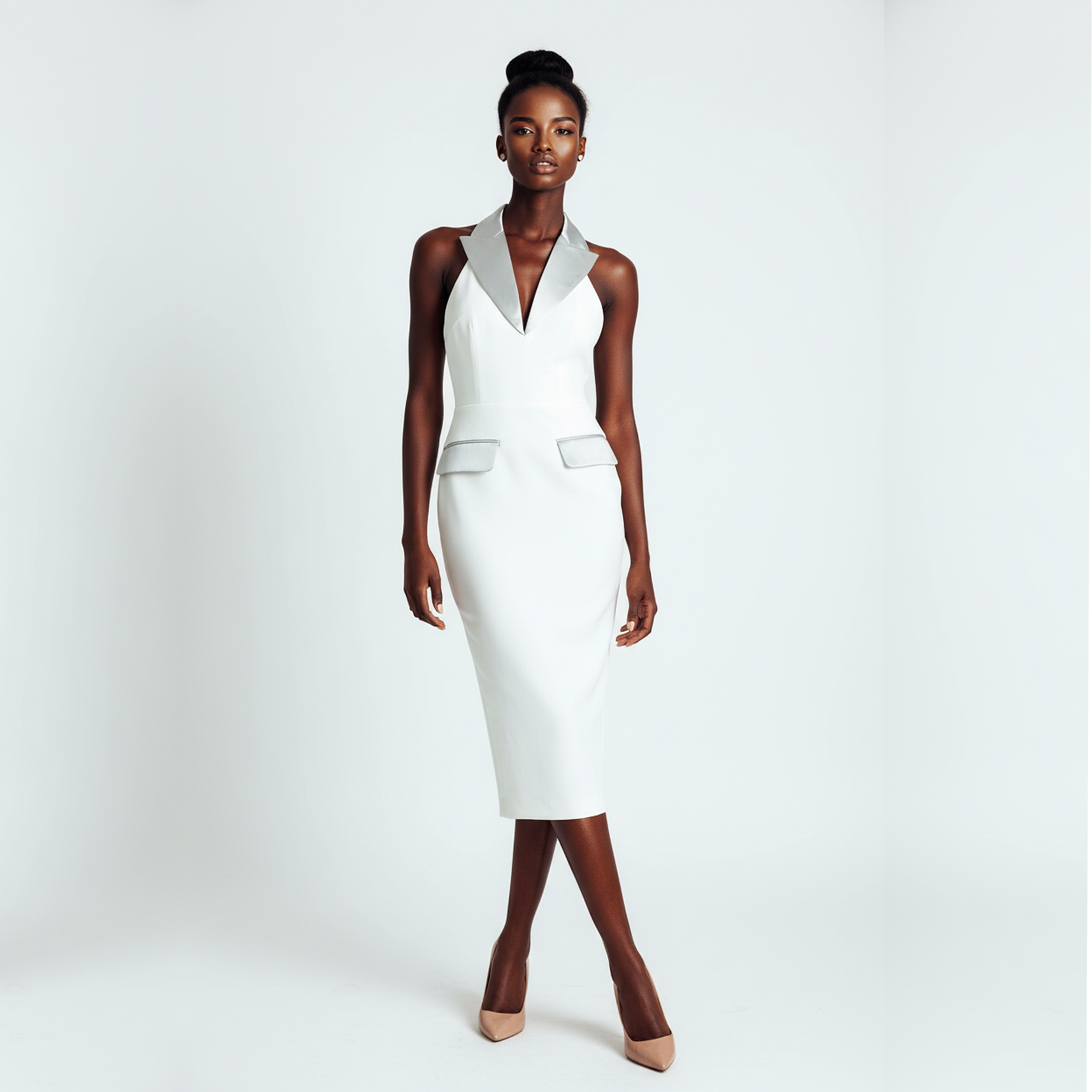 Woman wearing a white sleeveless dress on a plain background