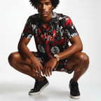 Man wearing a patterned shirt and black sneakers on a white background