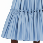 Close-up of a light blue skirt with ruffled hem on a white background