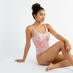 Woman wearing a floral one-piece swimsuit on a white background