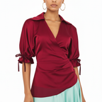A dress with a Red blouse with puff sleeves worn by a model on a white background
