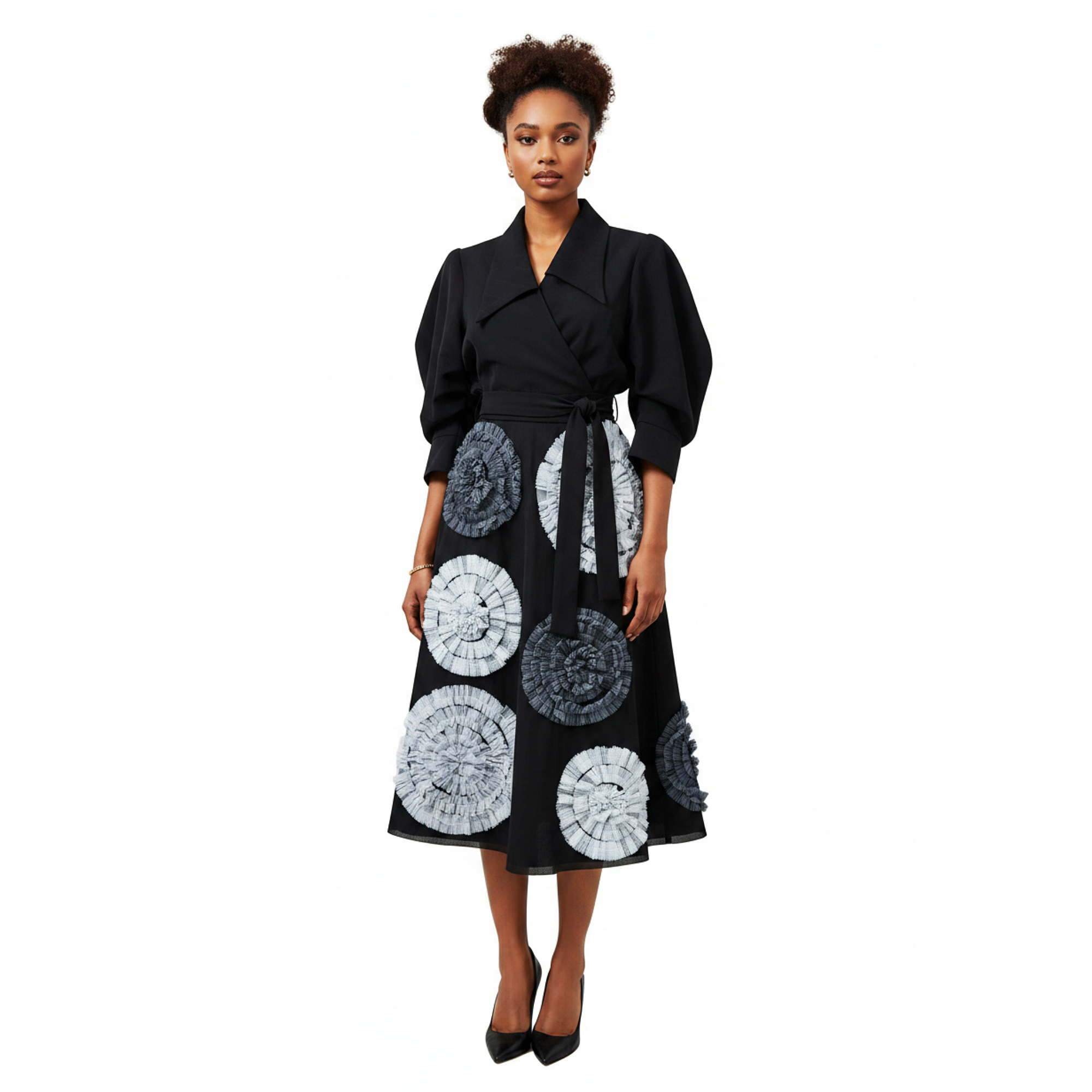Woman wearing a black coat with a patterned skirt on a white background