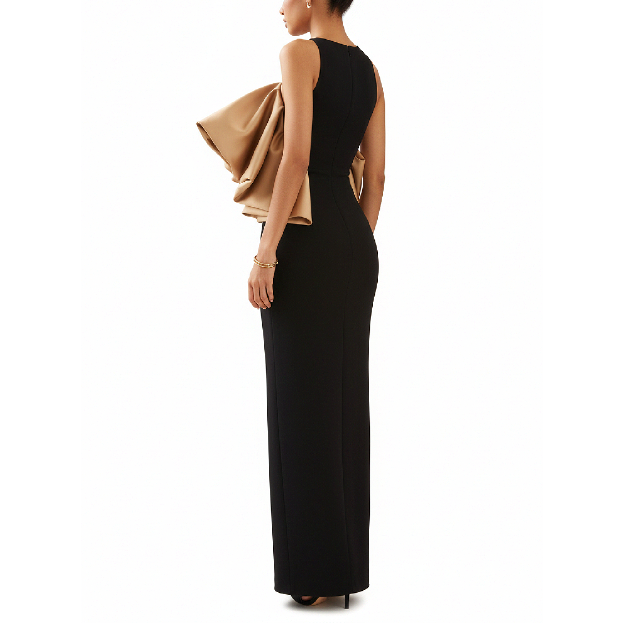Woman wearing a black evening gown with a beige jacket over her shoulder on a white background