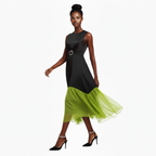 Woman wearing a black and green dress on a white background