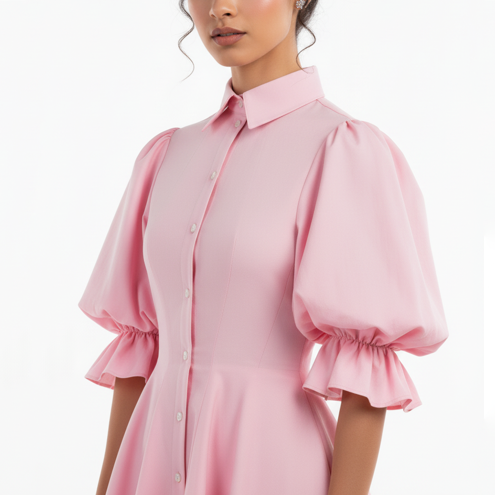 Pink dress with ruffled sleeves worn by a model on a white background