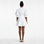 Woman wearing a white dress on a white background
