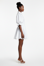Woman wearing a white dress on a white background