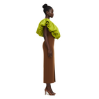 Woman wearing a green top and brown skirt on a white background