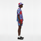 Person wearing a colorful outfit with a matching hat on a white background