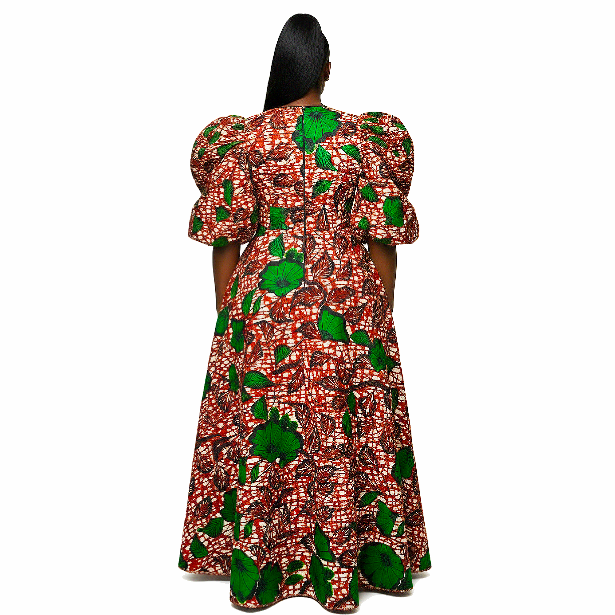 A woman viewed from the back wearing a long dress with puff sleeves and a red, white, and green abstract print on a white studio background.