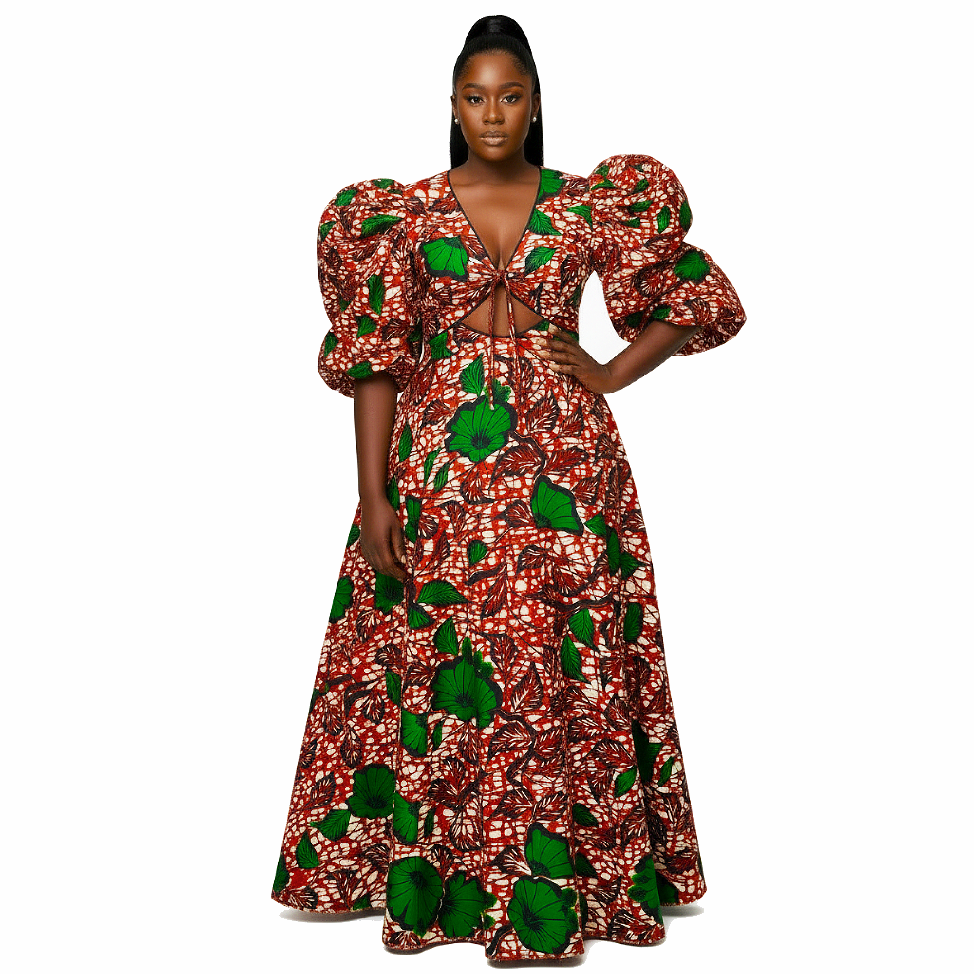 A woman modeling a floor-length African wax print maxi dress with a red, green, and white pattern, featuring dramatic puff sleeves, a deep V-neckline, and a front cutout.