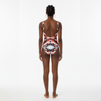 Person wearing a colorful one-piece swimsuit on a white background